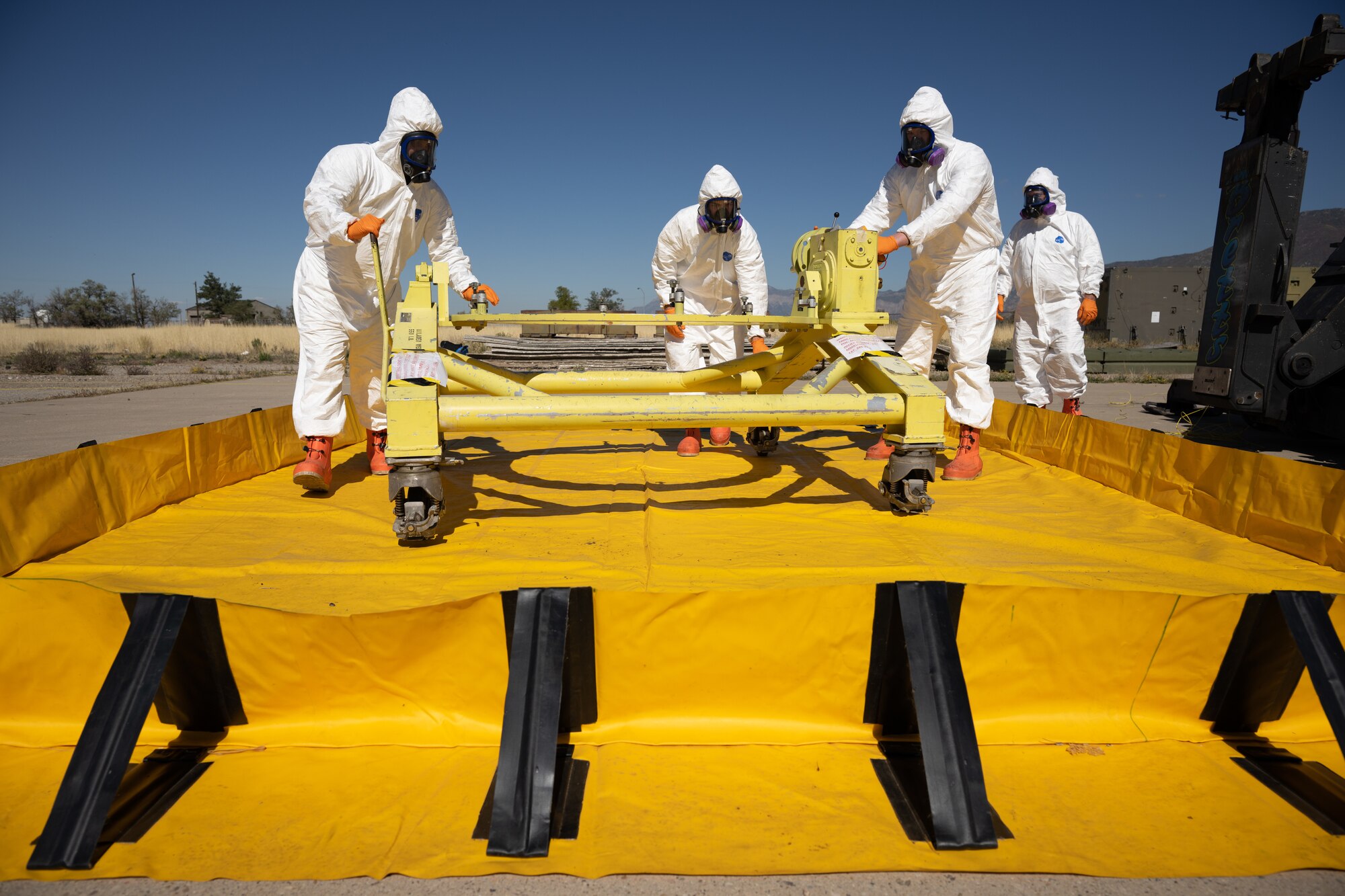 Members of the Missile Mishap Response Team move a fixture into a containment barrier during a training event at Hill Air Force Base, Utah, Oct. 4, 2022.