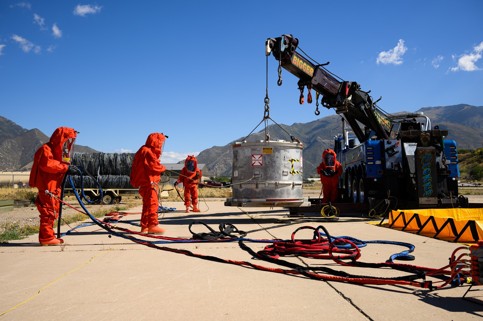Members of the Missile Mishap Response Team move a Mintueman III component container into a containment barrier during a training event at Hill Air Force Base, Utah, Oct. 4, 2022.