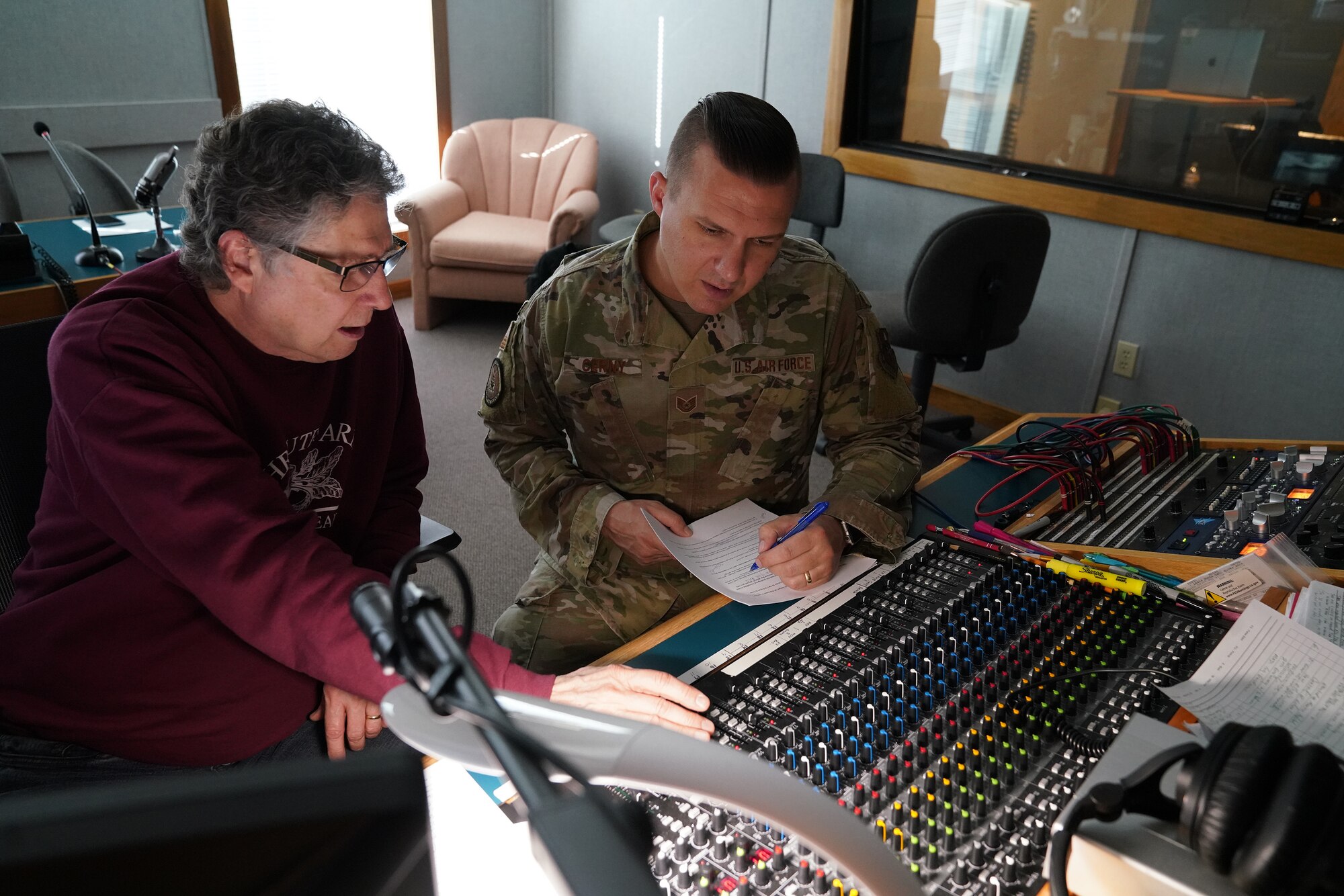 Air Force Recruiting Service’s Tech. Sgt. Greg Cerny, host of this year’s “Red, White and Air Force Blue Christmas” radio special, reviews program with Spotland Productions Engineer Ben Holland in Nashville.