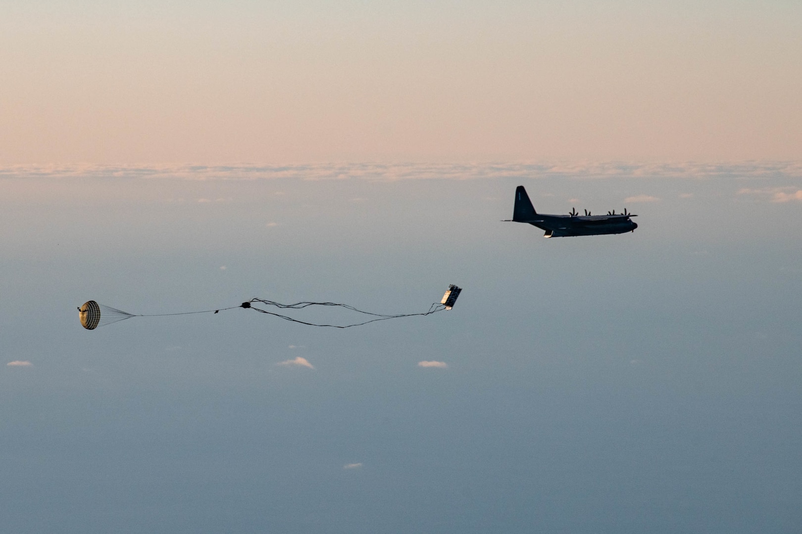 A palletized effects system falls from the cargo hold of a 352d Special Operations Wing MC-130J Commando II during a live-fire demonstration for ATREUS 22-4 at Andøya Space Defense Range, Norway, Nov. 9, 2022. This is the first time Rapid Dragon, a precision effects capability for medium-sized or larger cargo aircraft that allows U.S. and NATO forces a flexible rapid response option, has been employed in the U.S. European Command theater. (U.S. Air National Guard photo by Tech. Sgt. Brigette Waltermire)