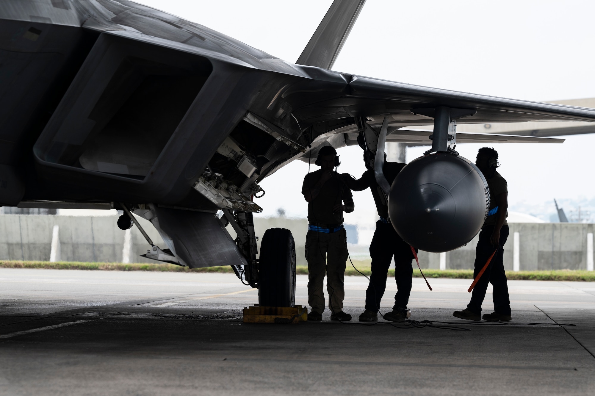 U.S. Air Force maintenance personnel assigned to the 3rd Aircraft Maintenance Squadron conduct recovery procedures on an F-22 Raptor assigned to the 525th Fighter Squadron as it arrives for a temporary deployment to Kadena Air Base, Japan, Nov. 8, 2022. The Raptors, hailing from Joint Base Elmendorf-Richardson, Alaska, will work in conjunction with local Kadena-based assets to enhance U.S. operational readiness to defend Japan and ensure a free and open Indo-Pacific. (U.S. Air Force photo by Senior Airman Jessi Roth)