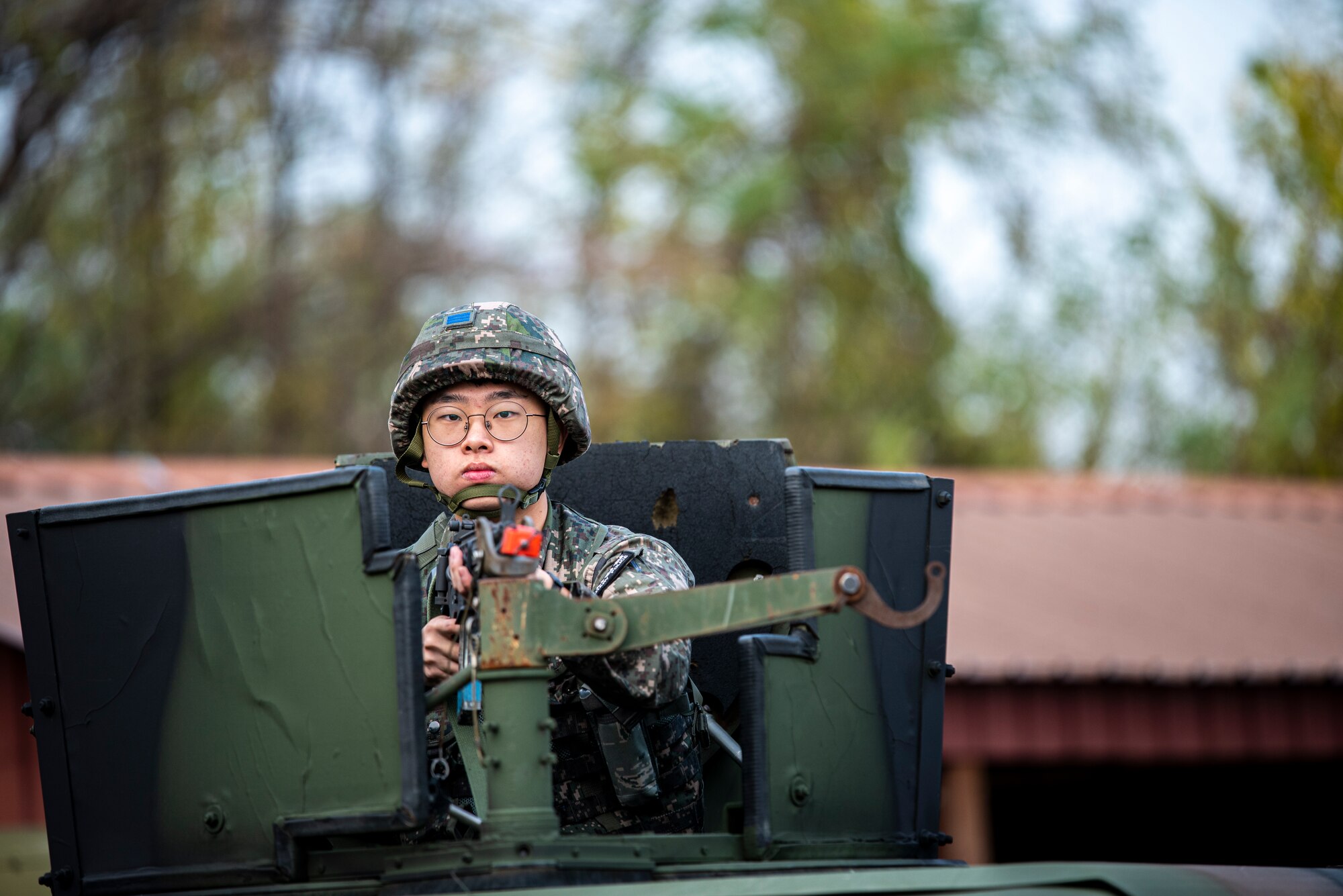 Republic of Korea Senior Airman Jungmin Lee, Military Policeman, watches for threats in the turret of a Humvee during a joint Combat Readiness Course (CRC) with 51st Security Forces Squadron Defenders at Osan Air Base, ROK, Nov. 3, 2022.