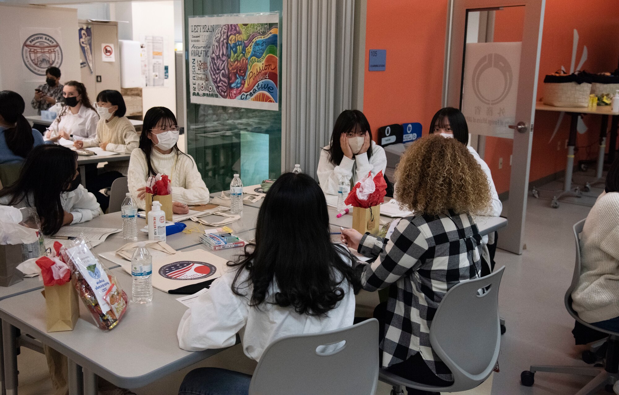 Japanese and American students sit around and get to know each other in their group.