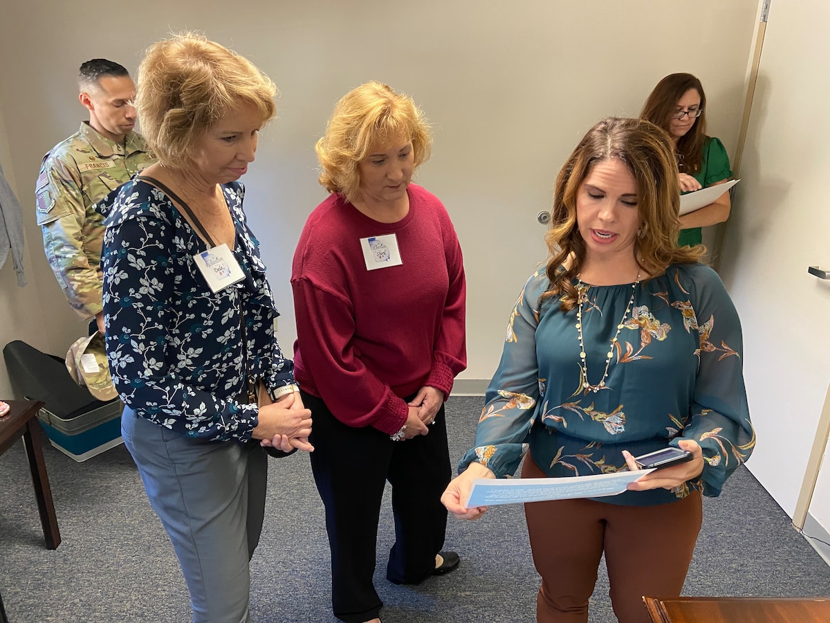 Photo shows group of people looking at paper