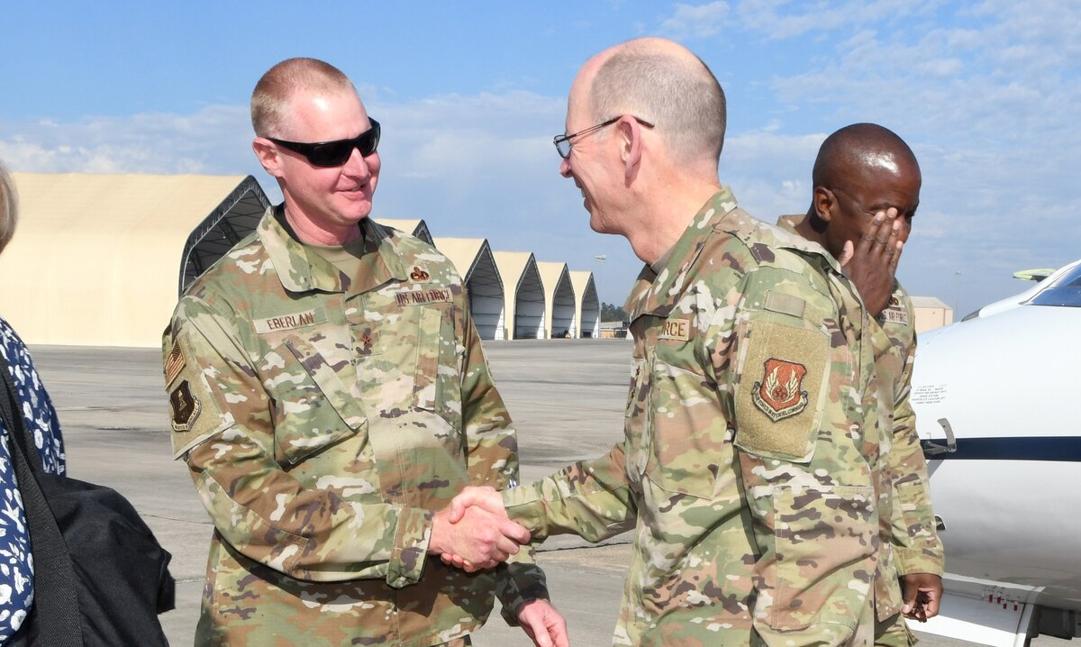 Photo shows two people shaking hands