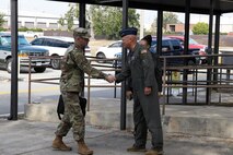 Photo shows two people shaking hands