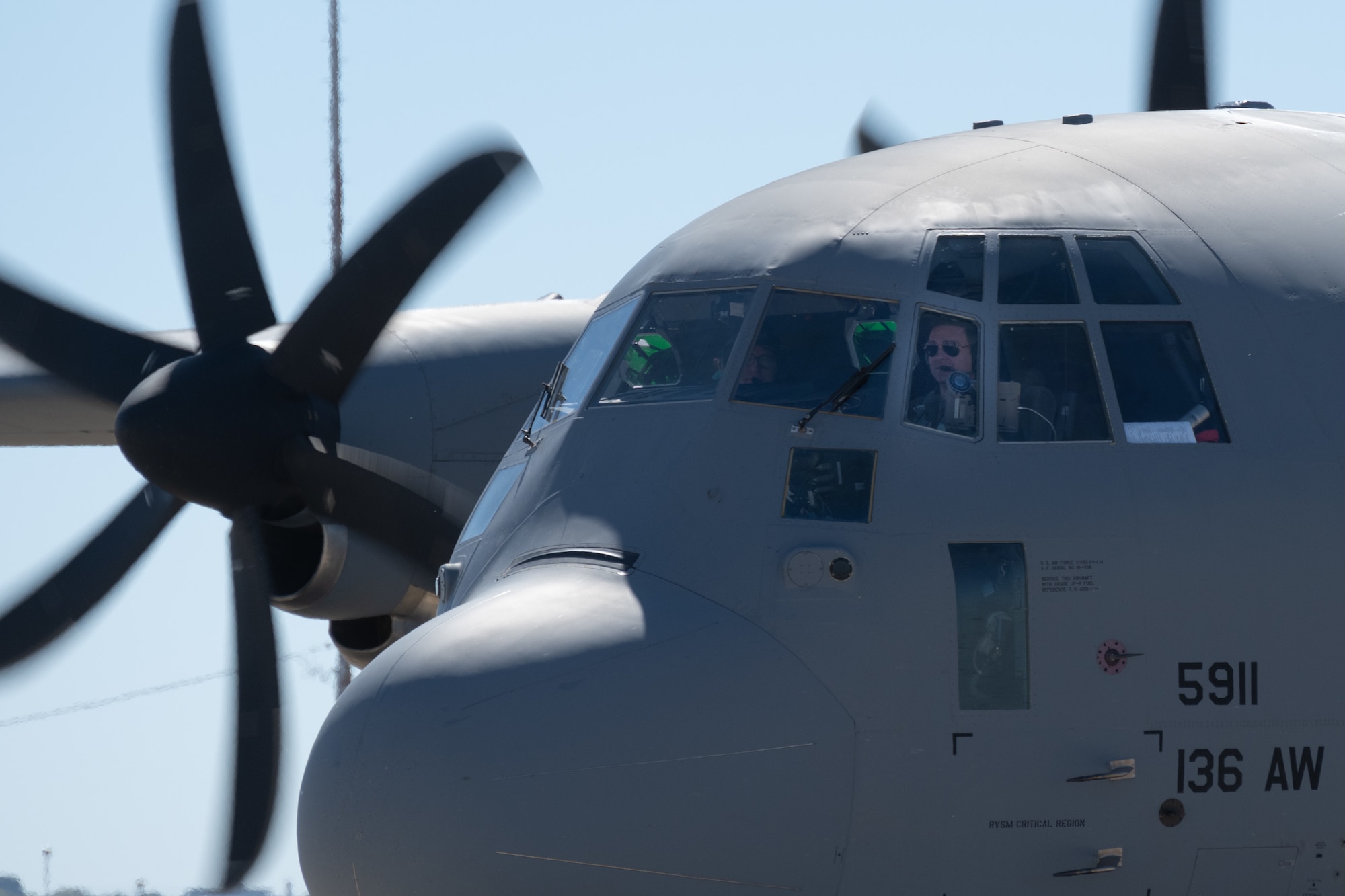 Pilot lands C-130J on runway.
