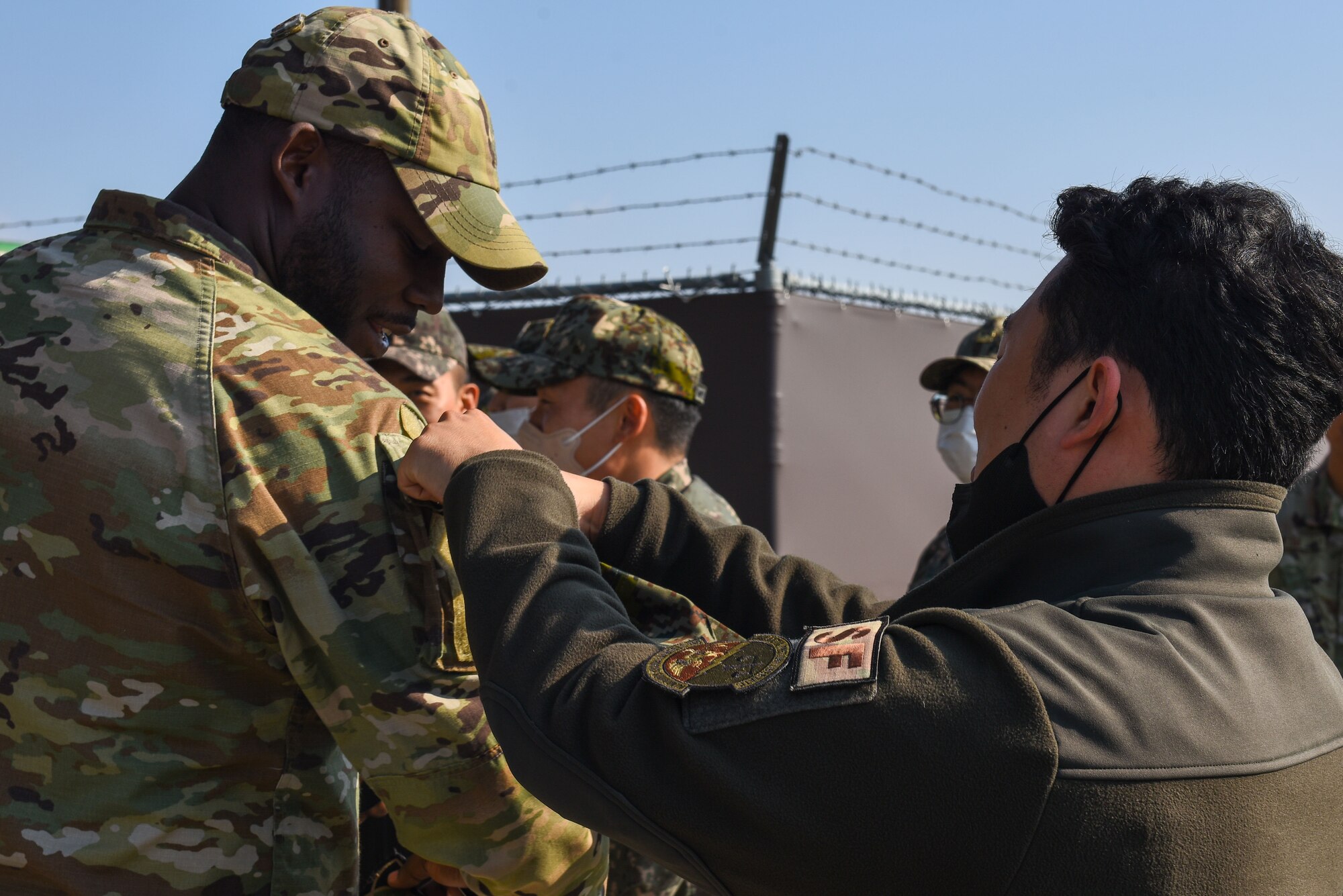 An 8th Fighter Wing Airman (left) trades patches with a Republic of Korea Army 35th Infantry Division soldier during an 8th Maintenance Group immersion tour at Kunsan Air Base, Republic of Korea, Nov. 8, 2022. Service members often trade patches to remember significant events in their careers. (U.S. Air Force photo by Tech. Sgt. Timothy Dischinat)