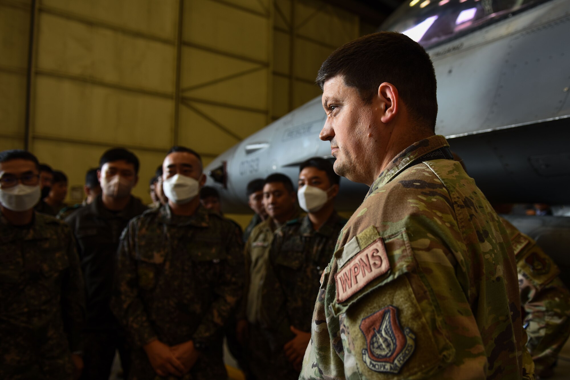 U.S. Air Force Tech. Sgt. Nikolai Yeakel, 8th Maintenance Group loading standardization crew chief, briefs Republic of Korea Army 35th Infantry Division and U.S. Army Soldiers during an immersion tour at Kunsan Air Base, Republic of Korea, Nov. 8, 2022. During the tour, participants learned more about the F-16 Fighting Falcon, to include the type of munitions that can be loaded onto the aircraft. (U.S. Air Force photo by Tech. Sgt. Timothy Dischinat)