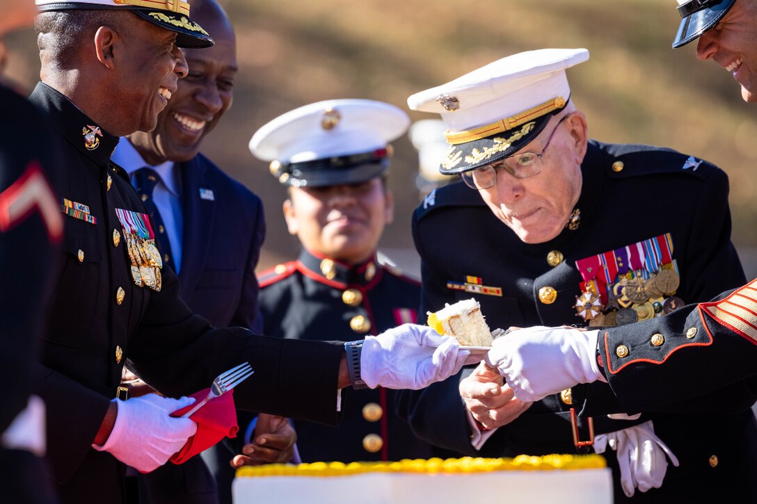 A Marine Corps veteran looks expectantly as he is offered a piece of cake.