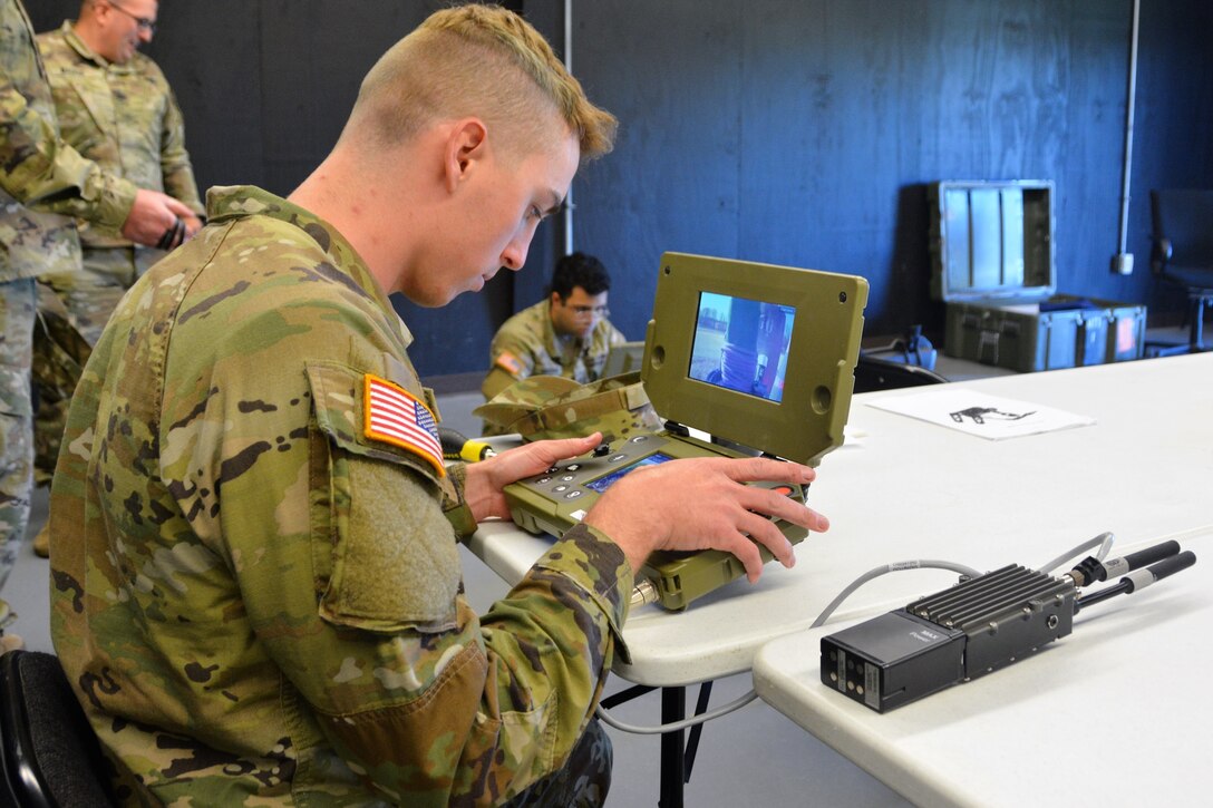 Cpl. Floyd Keim of Alpha Company, 103rd Brigade Engineer Battalion, 56th Stryker Brigade Combat Team uses a controller to remotely operate a Common Robotic System – Individual during training on Nov. 9, 2022, at Fort Indiantown Gap, Pa. The CRS-I is a 32-pound, tracked robot with multiple cameras and an extendable arm that can fit into a medium ruck sack or an assault pack.