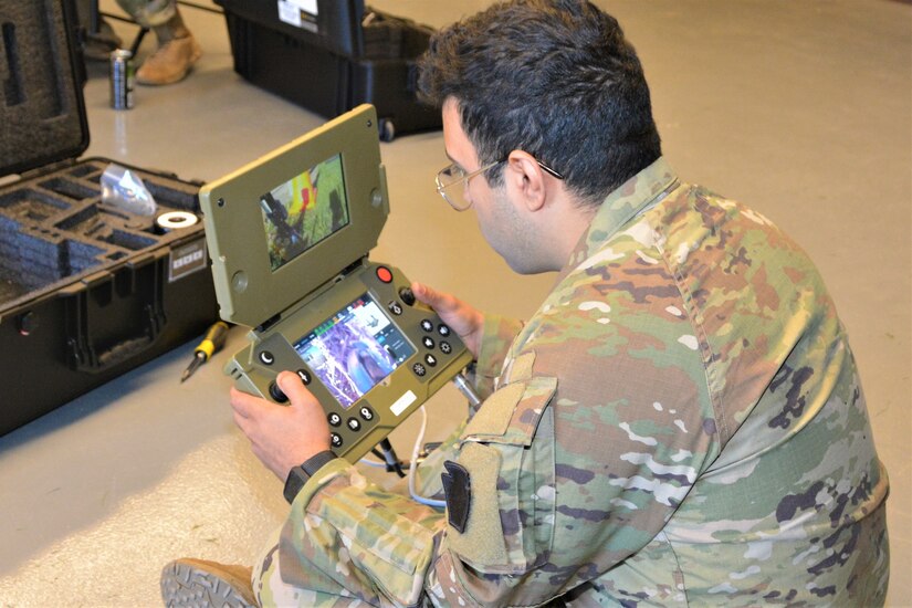 Spc. Antonio Santiago of Bravo Company, 103rd Brigade Engineer Battalion, 56th Stryker Brigade Combat Team uses a controller to remotely operate a Common Robotic System – Individual during training on Nov. 9, 2022, at Fort Indiantown Gap, Pa. The CRS-I is a 32-pound, tracked robot with multiple cameras and an extendable arm that can fit into a medium ruck sack or an assault pack.