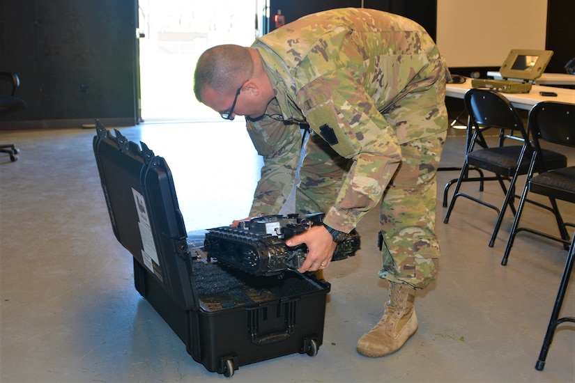 Staff Sgt. Matthew Wacker of Headquarters and Headquarters Company, 876th Brigade Engineer Battalion, 2nd Infantry Brigade Combat Team places a Common Robotic System – Individual into its case during training on Nov. 9, 2022, at Fort Indiantown Gap, Pa. The CRS-I is a 32-pound, tracked robot with multiple cameras and an extendable arm that can fit into a medium ruck sack or an assault pack.