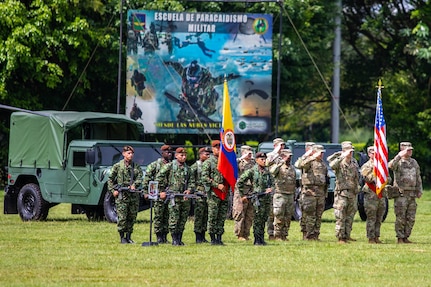 U.S. and Colombian Army Soldiers render salutes during the opening ceremony of Exercise Southern Vanguard