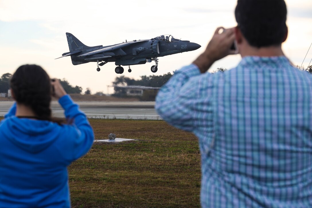 Students of Leadership Carteret take photos of an AV-8B Harrier during a tour of Marine Corps Auxiliary Landing Field Bogue, North Carolina, on Nov. 2, 2022. Leadership Carteret is an annual program run by the Carteret County Chamber of Commerce and gives local leaders, business owners, and professionals knowledge of the economic and social impact of their neighboring Marine Corps installation.