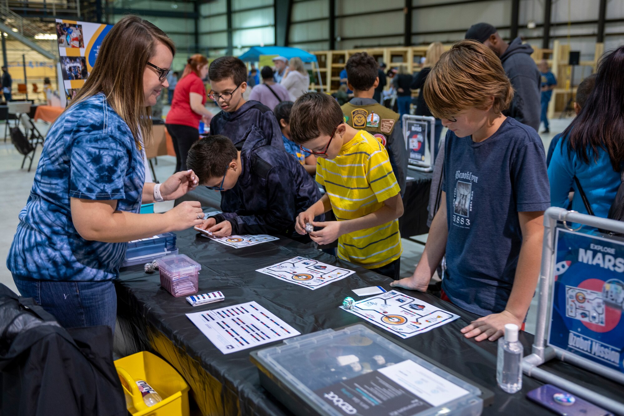 STARBASE Martinsburg instructor, Ashley Spies, assists youth with a STEM activity at the Family STEM Night at the former Sino Swearingen hangar at Eastern West Virginia Regional Airport, October 26, 2022. The event was co-hosted by STARBASE Martinsburg and the Air National Guard’s Drug Demand Reduction Program, in honor of Red Ribbon Week.