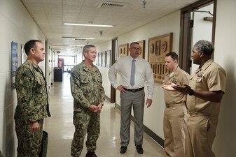 Rear Adm. Pete Garvin, center-left, commander, Naval Education and Training Command (NETC), speaks with leadership assigned to Surface Warfare Firefighting and Damage Control School San Diego as part of a visit to San Diego area NETC commands, Oct. 31, 2022.