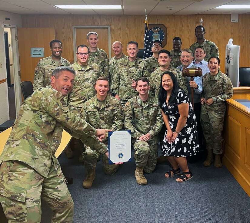 JBMDL and 87th ABW commander poses for a picture with 87 ABW JA staff.