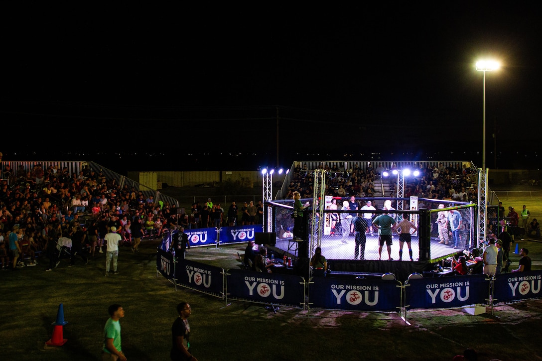 U.S. Marines, Sailors and their families watch the mixed martial arts Fight Night event at Marine Corps Air Ground Combat Center (MCAGCC), Twentynine Palms, California, Sept. 23, 2022. Marine Corps Community Services hosted Fight Night for the service members stationed at MCAGCC to provide the opportunity to enjoy live entertainment closer to home. (U.S. Marine Corps photo by Lance Cpl. Jonathan Willcox)