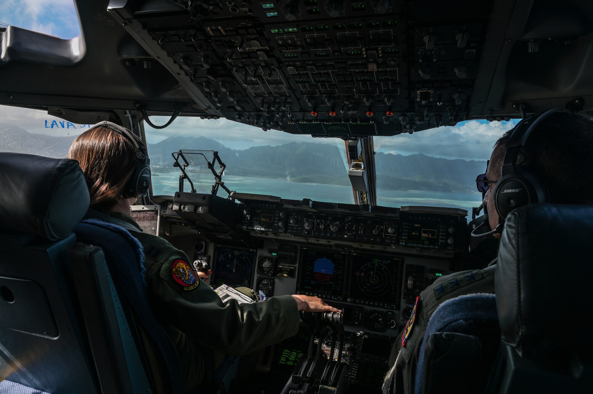 U.S. Air Force Capt. Carol Champion, 535th Airlift Squadron C-17 Globemaster III pilot, flies alongside U.S. Air Force Lt. Gen. David Nahom, commander of Alaskan NORAD Region, Alaskan Command and 11th Air Force, around the Hawaiian Islands as part of a 15th Wing immersion tour Oct. 24, 2022. Nahom was taken on a two-hour familiarization flight where the aircrew provided an overview of the 535th AS’s mission and demonstrated the capabilities of the cargo aircraft. (U.S. Air Force photo by Staff Sgt. Alan Ricker)
