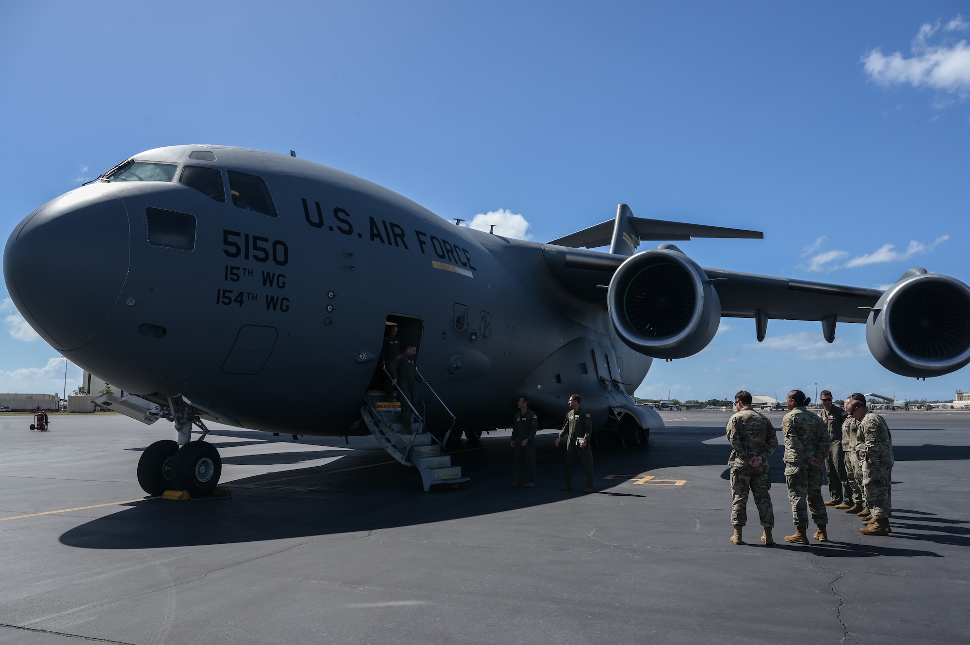 Airmen assigned to the 15th Wing greet U.S. Air Force Lt. Gen. David Nahom, commander of Alaskan NORAD Region, Alaskan Command and 11th Air Force, at Joint Base Pearl Harbor-Hickam, Hawaii, after his flight on a C-17 Globemaster III Oct. 24, 2022. Nahom was taken on a two-hour familiarization flight where the aircrew provided an overview of the squadron’s mission and demonstrated the capabilities of the cargo aircraft. (U.S. Air Force photo by Staff Sgt. Alan Ricker)