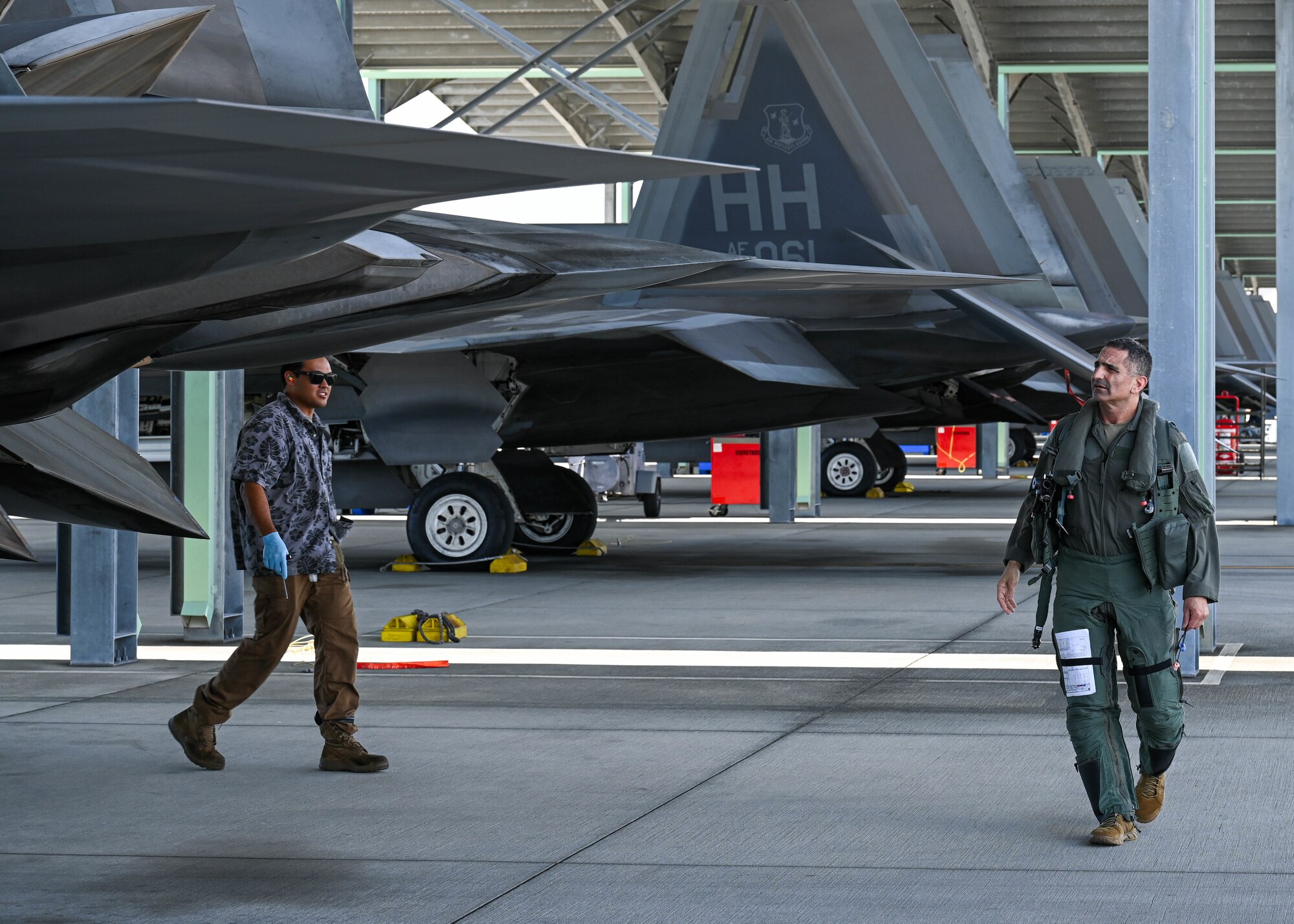 U.S. Air Force Lt. Gen. David Nahom, commander of Alaskan NORAD Region, Alaskan Command and 11th Air Force, inspects an F-22 Raptor before his flight at Joint Base Pearl Harbor-Hickam, Hawaii, Oct. 28, 2022. Nahom flew with members of the 19th Fighter Squadron, the Fighting Gamecocks, during an immersion tour of Hickam Field. (U.S. Air Force photo by Senior Airman Zoie Cox)