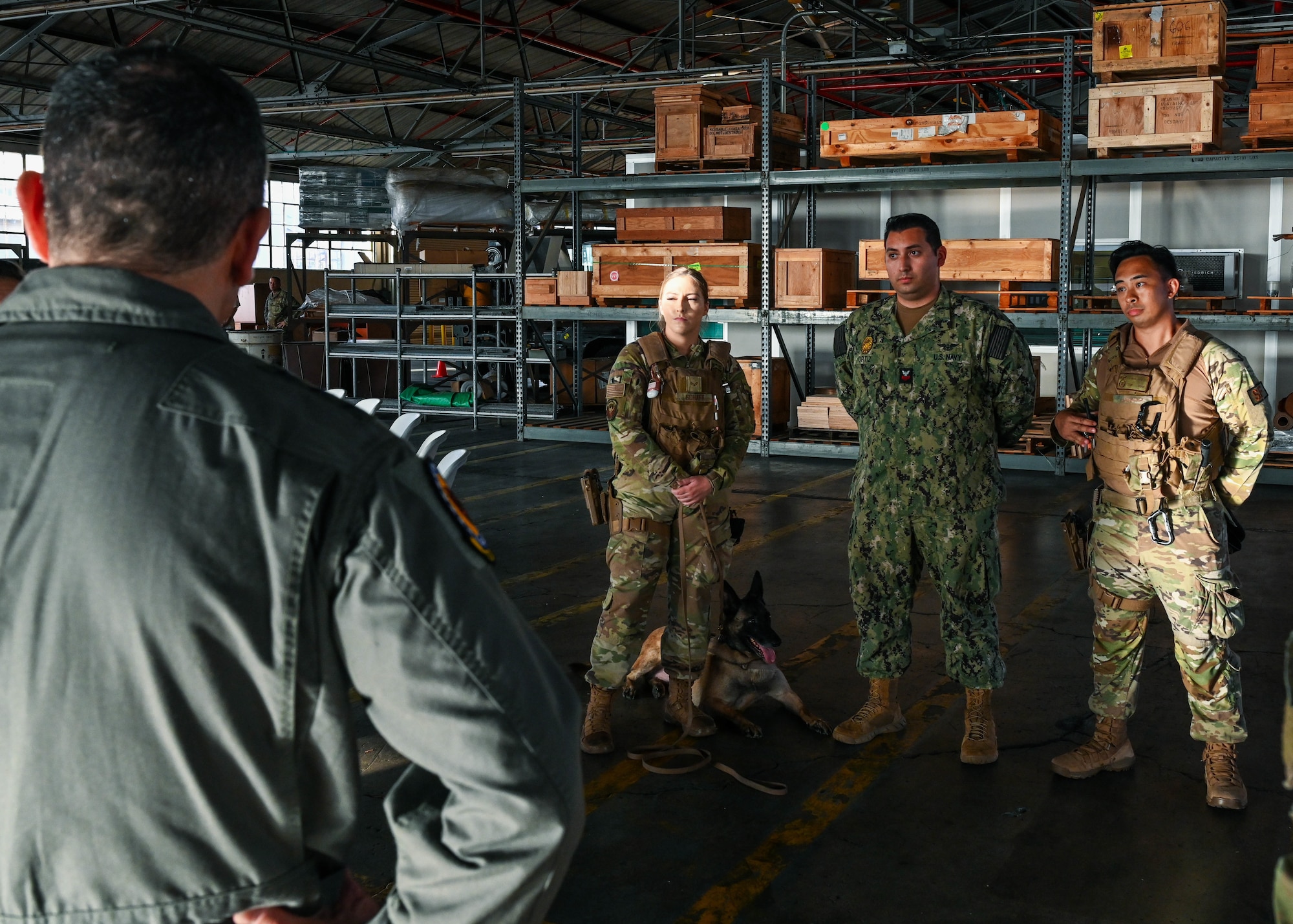 Law enforcement members assigned to Joint Base Pearl Harbor-Hickam brief U.S. Air Force Lt. Gen. David Nahom, commander of Alaskan NORAD Region, Alaskan Command and 11th Air Force, on their roles as military working dog handlers Oct. 28, 2022, at JBPHH, Hawaii. The 647th Air Base Group’s missions were highlighted along with the innovations and successes of the joint base. (U.S. Air Force photo by Senior Airman Zoie Cox)