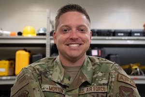 A man smiles for a portrait photo.