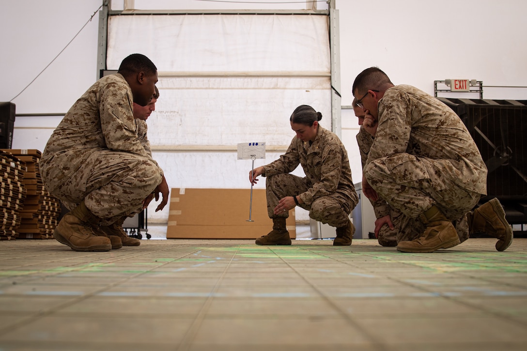 U.S. Marine Corps Maj. Amanda WhippoBonilla, a logistics officer with Marine Wing Headquarters Squadron 2, 2nd Marine Aircraft Wing, receives peer critiques, following her logistics plan presentation for a notional operation during an Advanced Expeditionary Logistics Operations Course (AXLOC) at Marine Corps Air Ground Combat Center, Twentynine Palms, California, Sept. 29, 2022. AXLOC incorporates extensive use of case studies, wargaming and decision forcing cases, and rapid planning to train personnel to effectively close and sustain naval expeditionary forces in support of distributed maritime operations and expeditionary advanced base operations. (U.S. Marine Corps photo by Lance Cpl. Jonathan Willcox)