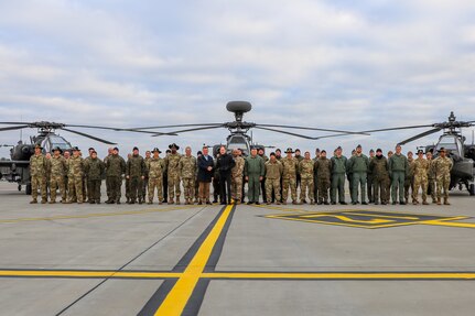 Deputy Prime Minister and Minister of Defense Mariusz Blaszczak and U.S. Ambassador to Poland, Mark Brzezinski shake hands during a group photo with the U.S. Soldiers of the 120th Regional Support Group of the Maine National Guard, 1st Armoured Division Combat Aviation Brigade, and Polish Soldiers of the 33rd Air Base following the groundbreaking ceremony of the two Polish Provided Infrastructure projects in Powidz, Poland on Nov. 7, 2022.