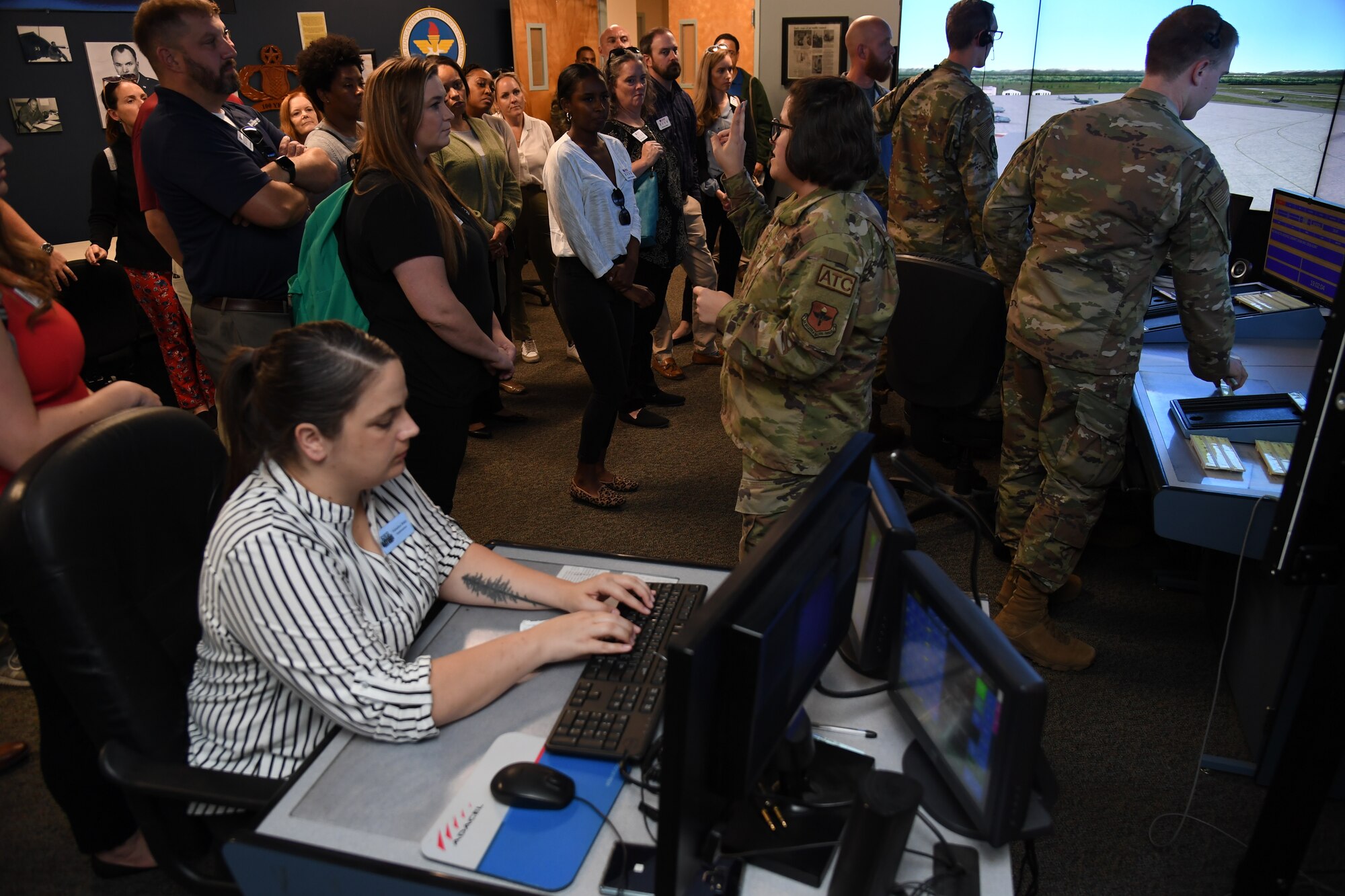 U.S. Air Force Tech. Sgt. Courtney Way, 334th Training Squadron instructor, briefs members of the Mississippi Gulf Coast Chamber of Commerce Leadership Gulf Coast on the air traffic control training course inside Cody Hall at Keesler Air Force Base, Mississippi, Nov. 9, 2022.