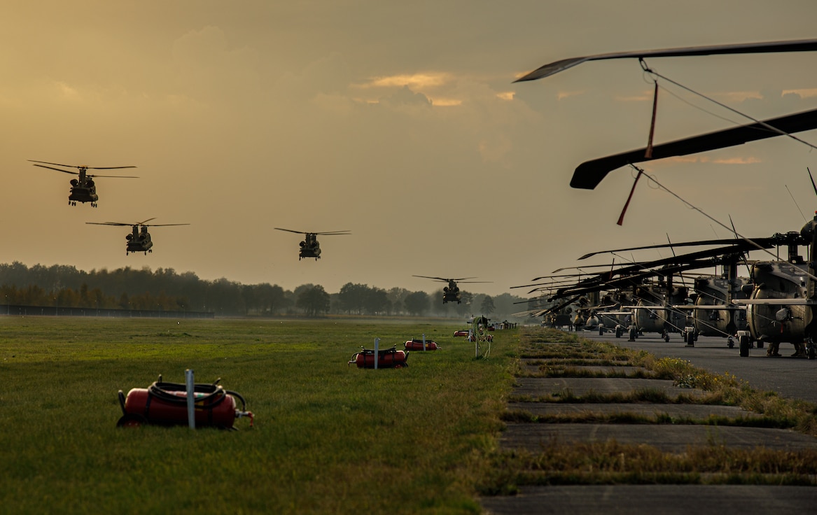 Four U.S. Army CH-47F Chinook helicopters from 1st Battalion, 214th Aviation Regiment (General Support Aviation Battalion), 12th Combat Aviation Brigade, prepare to land during exercise Falcon Autumn 22 at Vredepeel, Netherlands, Nov. 4, 2022. 12 CAB is among other units assigned to V Corps, America's Forward Deployed Corps in Europe. They work alongside NATO Allies and regional security partners to provide combat-ready forces, execute joint and multinational training exercises, and retain command and control for all rotational and assigned units in the European Theater. (U.S. Army photo by Staff Sgt. Thomas Mort)
