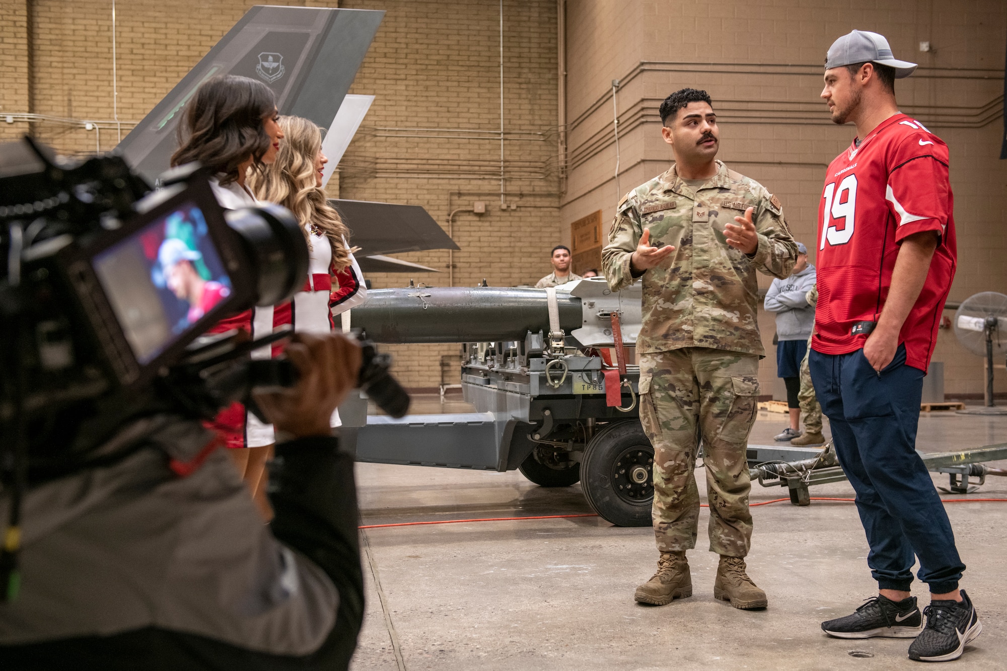 U.S. Air Force Staff Sgt. Jorge Aparicio-Aguilar, 56th Component Maintenance Squadron weapons lead crew member, speaks with Trace McSorley, Arizona Cardinals quarterback, Nov. 1, 2022, at Luke Air Force Base, Arizona.
