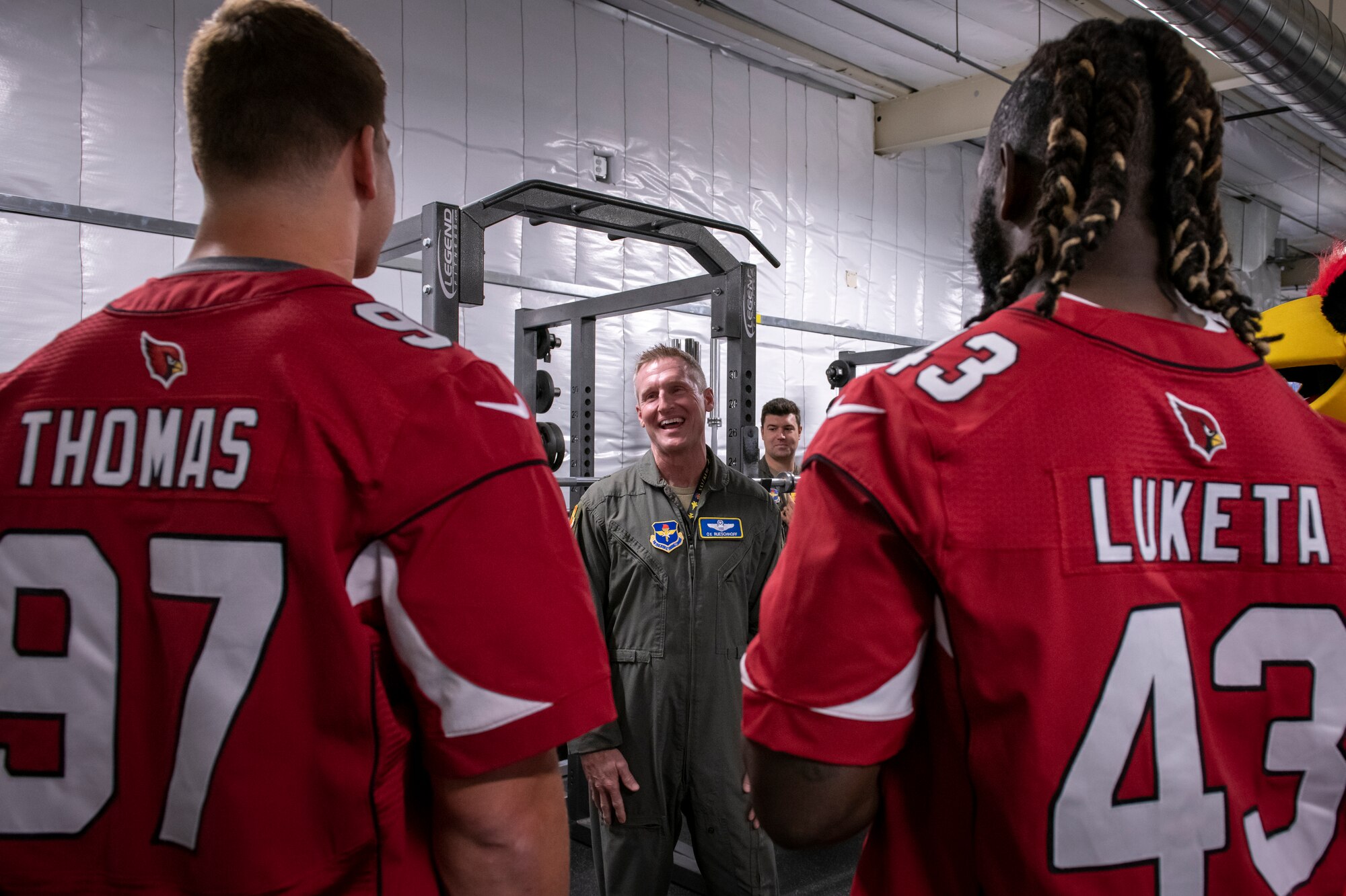 U.S. Air Force Brig. Gen. Jason M. Rueschhoff, 56th Fighter Wing commander, greets Cameron Thomas and Jesse Luketa, Arizona Cardinals offensive linebackers, Nov. 1, 2022, at Luke Air Force Base, Arizona.