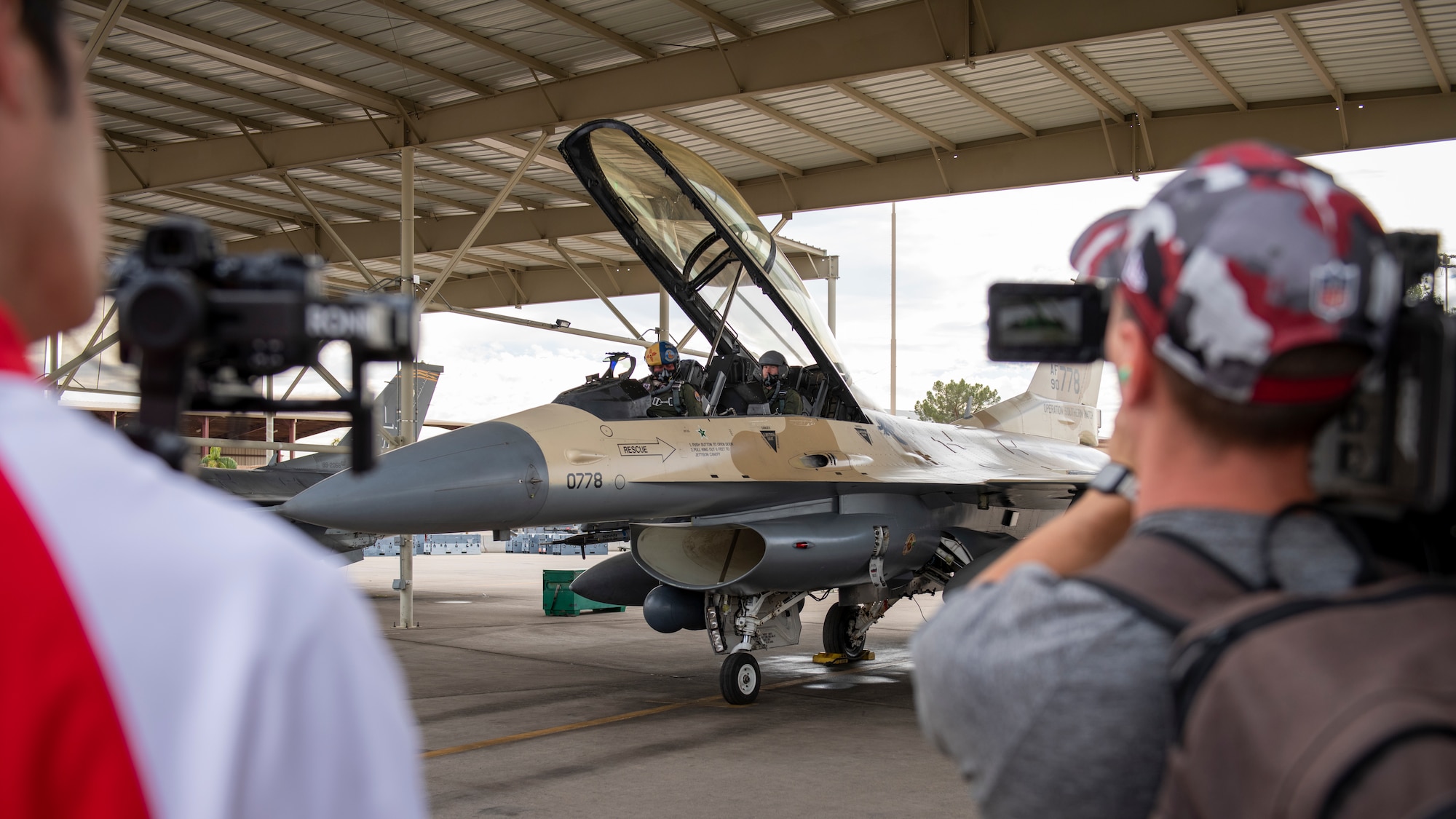 U.S. Air Force Maj. Aaron Johnson, 69th Fighter Squadron F-16 instructor pilot, and Dennis Gardeck, Arizona Cardinals offensive linebacker, prepare for flight in an F-16D Fighting Falcon Nov. 1, 2022, at Luke Air Force Base, Arizona.