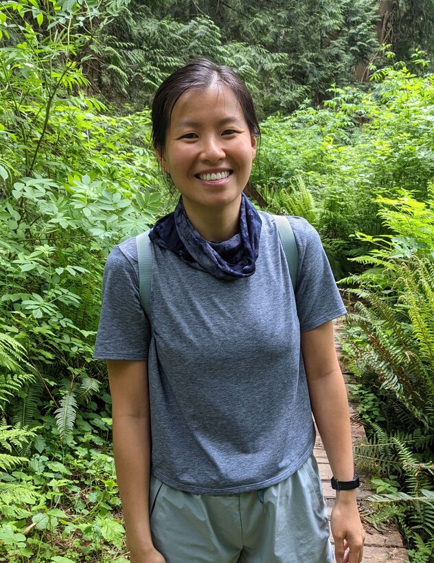 Photo of Connie Chow standing on a trail along the Fragrance Lake Trail.
