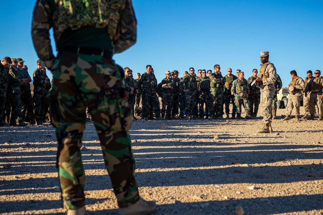 U.S. Marine Corps Sgt. Jonathan Southward, a motor vehicle operator with 1st Transportation Support Battalion, 1st Combat Logistics Regiment, 1st Marine Logistics Group (MLG), gives a safety brief to Marines and Dutch Royal Marines with 2nd Marine Combat Group before they drive during a tactical vehicle familiarization course at Marine Corps Air Ground Combat Center, Twentynine Palms, California, Oct. 19, 2022. 1st MLG accepted the Dutch Royal Marines request to train with U.S. Marines tactical vehicles to familiarize themselves with Marine Corps vehicles so they can be equipped to utilize U.S. equipment should the need arise. (U.S. Marine Corps photo by Lance Cpl. Jonathan Willcox)