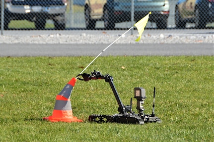 A remotely operated Common Robotic System – Individual uses its extendable arm to remove a flag from a cone during training on Nov. 9, 2022, at Fort Indiantown Gap, Pa. The CRS-I is a 32-pound, tracked robot with multiple cameras and an extendable arm that can fit into a medium ruck sack or an assault pack.