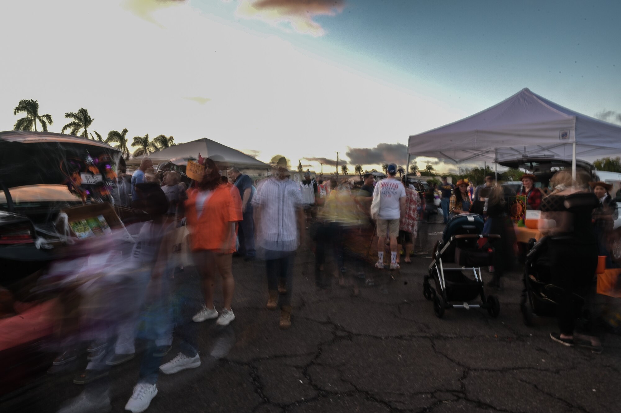Trick-or-treaters walk past decorated vehicles during the Trunks of Treats event at Joint Base Pearl Harbor-Hickam, Hawaii, Oct. 28, 2022. Military and civilian volunteers decorated vehicles, dressed up in costumes and handed out candy to multiple trick-or-treaters. (U.S. Air Force photo by Staff Sgt. Alan Ricker)