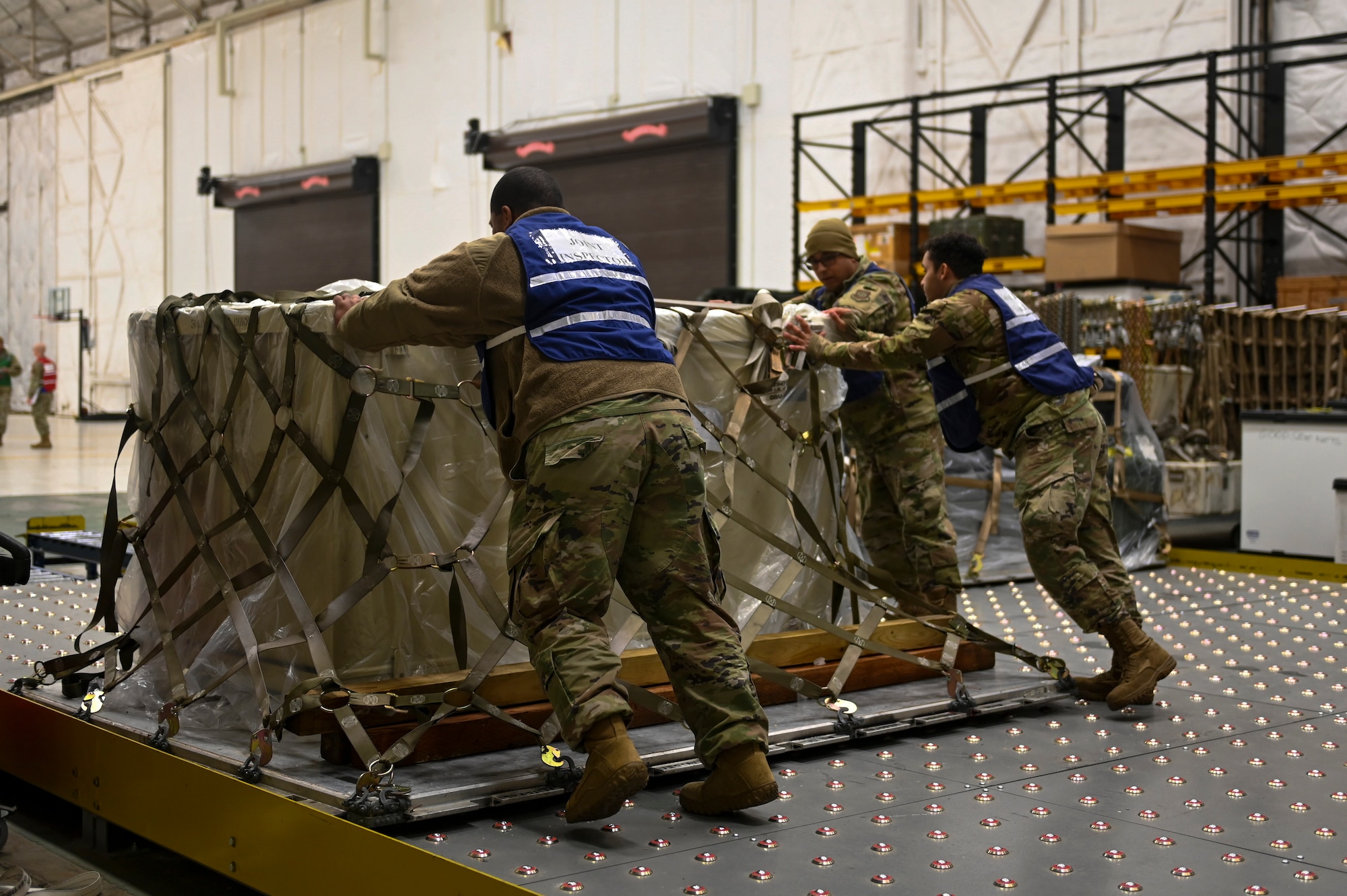 Airmen from the 92nd Logistic Readiness squadron inspect and move a pallet of equipment for processing during Titan Fury 23-1 at Fairchild Air Force Base, Washington, Nov. 7, 2022. during the Titan Fury 23-1 exercise. By conducting exercises like Titan Fury, Team Fairchild hones the skills required to execute its air refueling and supporting strategic deterrence missions as the world’s premier air refueling wing. (U.S. Air Force photo by Capt. Teri Bunce)