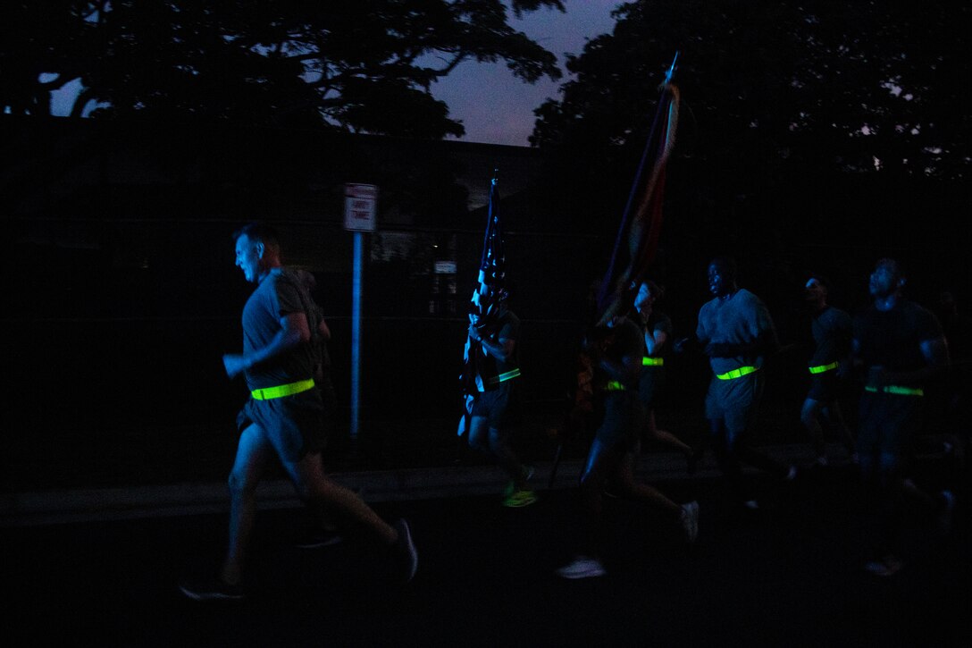 U.S. service members with Headquarters Battalion, Marine Corps Base Hawaii, run in formation during a motivational run, MCBH, Nov. 3, 2022. The purpose of the run was to enhance unit morale, increase physical and mental fitness, and to commemorate the 247th Marine Corps Birthday. (U.S. Marine Corps photo by Lance Cpl. Terry Stennett III)