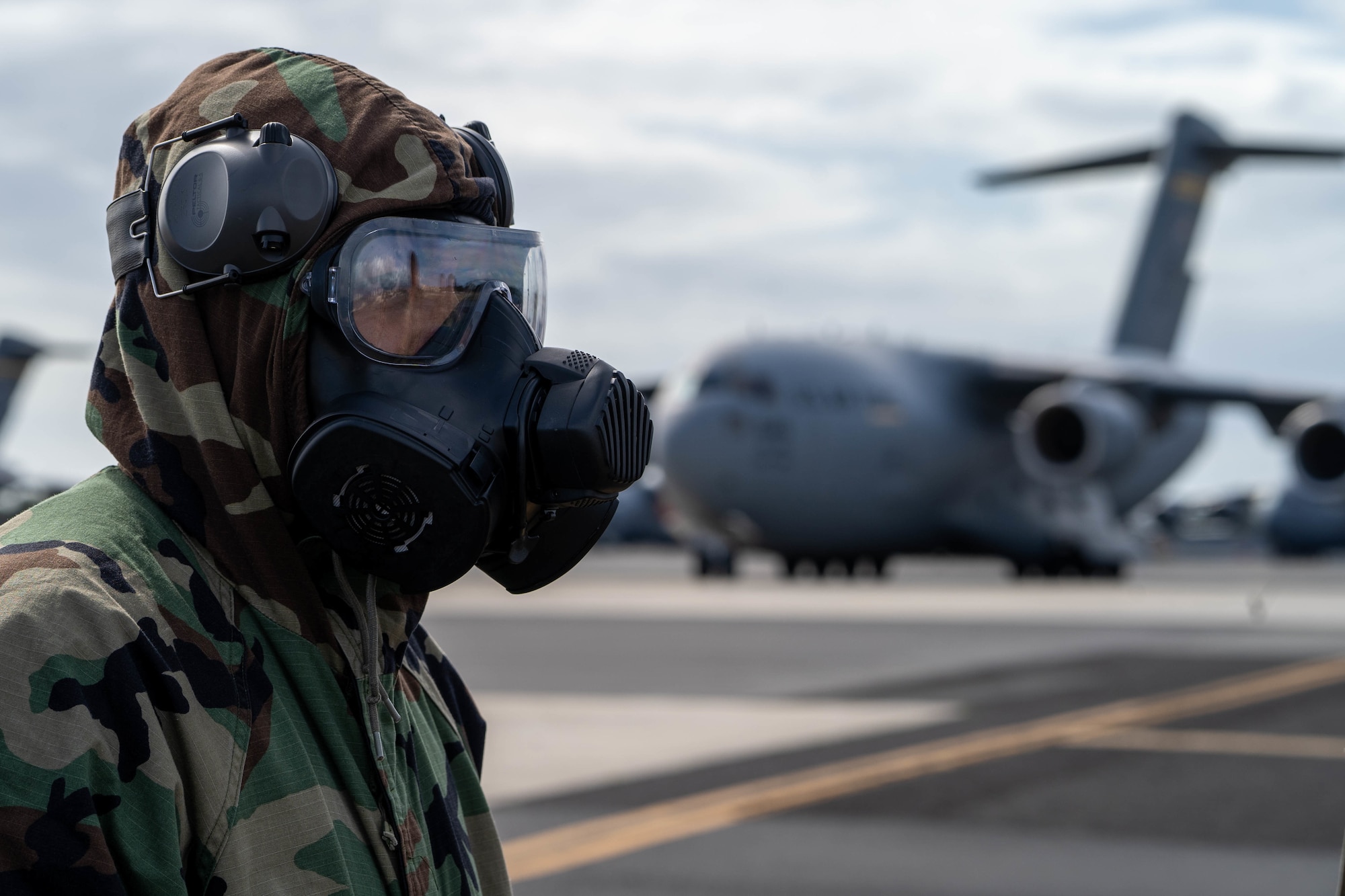 Master Sgt. Dominic Santos, 15th Aircraft Maintenance Squadron production superintendent, waits for the incident commander during a decontamination exercise at Joint Base Pearl Harbor-Hickam, Hawaii, Nov. 9, 2022. Hickam Airmen trained  how to decontaminate an aircraft, aircrew and cargo that has been exposed to a chemical or biological agent to maintain operational readiness. (U.S. Air Force photo by Senior Airman Makensie Cooper)