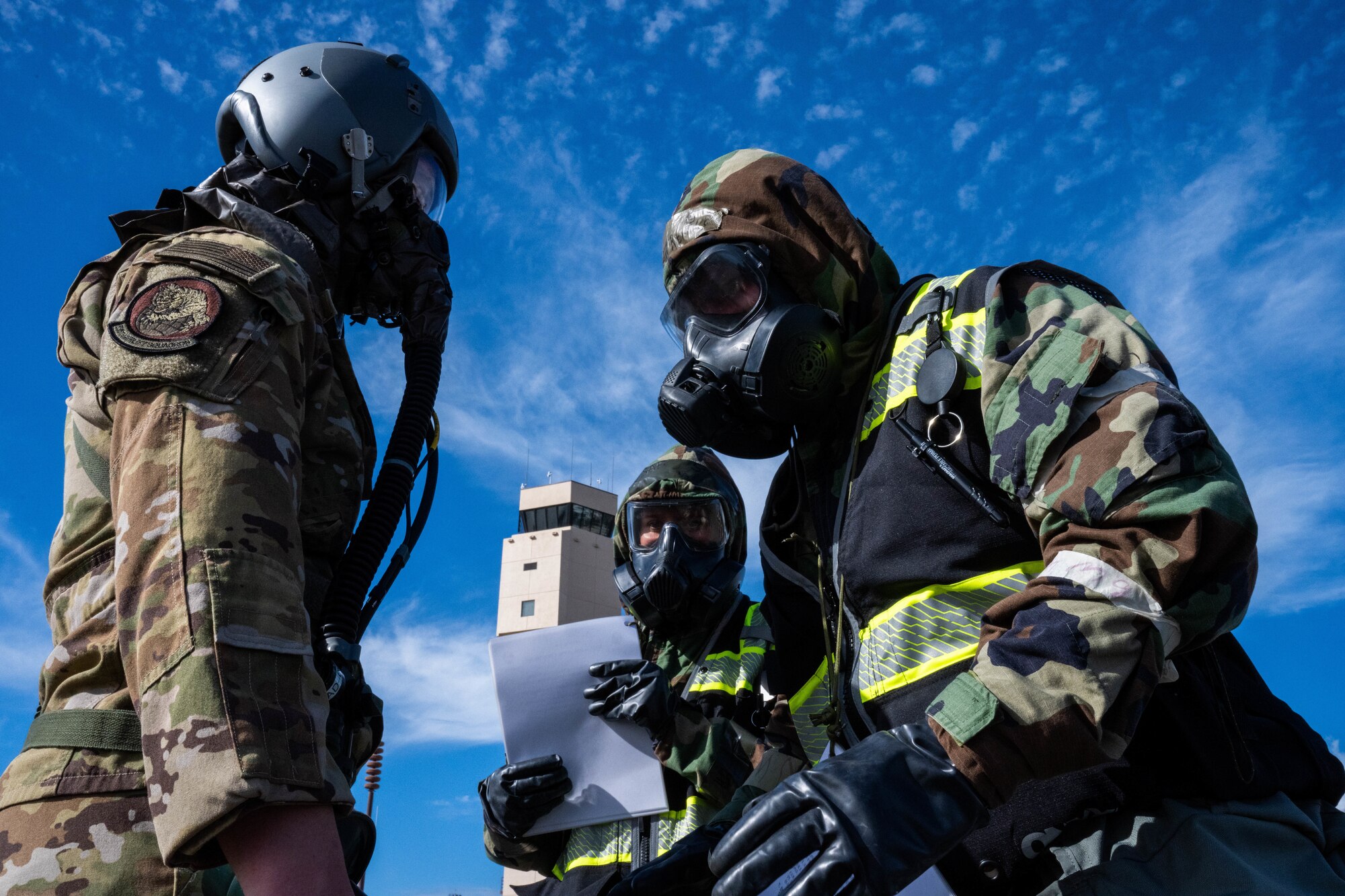 Airmen assigned to the 15th Operations Support Squadron processes 1st Lt. Erik Braunstein, 535th Airlift Squadron pilot, through the Aircrew Contamination Control Center during a decontamination exercise at Joint Base Pearl Harbor-Hickam, Hawaii, Nov. 9, 2022. This exercise scenario simulated an aircraft contaminated in a chemical attack giving Hickam airmen an opportunity to exercise treating aircrew and offloading contaminated cargo. (U.S. Air Force photo by Senior Airman Makensie Cooper)