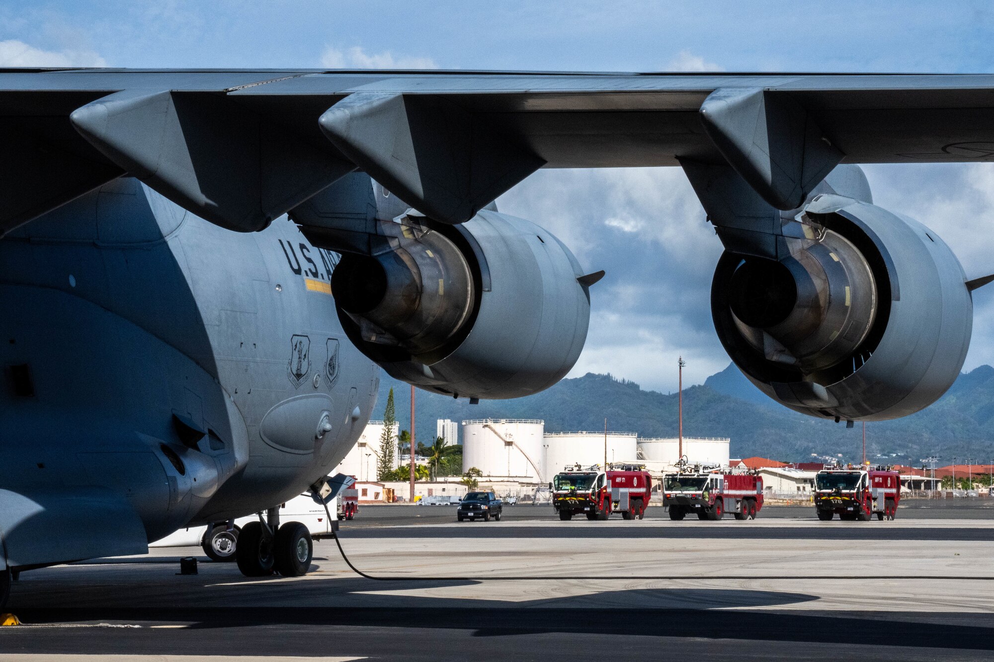 Personnel assigned to Federal Fire Department Hawaii wait to respond to a C-17 Globemaster III during a decontamination exercise at Joint Base Pearl Harbor-Hickam, Hawaii, Nov. 9, 2022. First responders trained alongside Hickam airmen such as aircrew flight equipment technicians during the exercise to maintain mission readiness. (U.S. Air Force photo by Senior Airman Makensie Cooper)