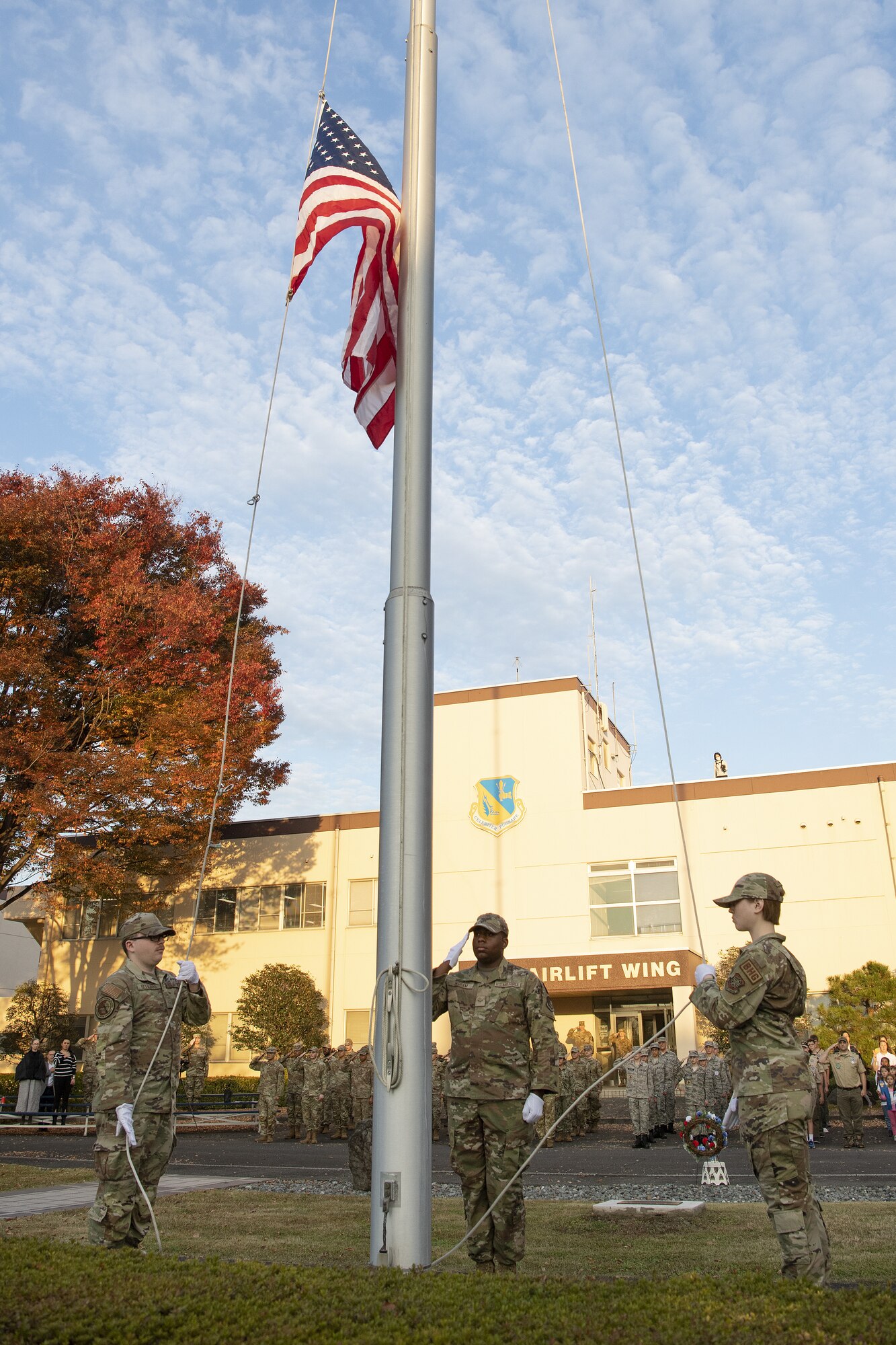 From left to right, Airman 1st Class Pierce DeFilippo, Airman 1st Class Jatravious Ingram, and Airman 1st Class Elyse Wilson, all Yokota Air Base honor guard members, participate in a Retreat Ceremony as part of the 2022 Yokota Veterans Day Ceremony at Yokota Air Base, Japan, Nov. 10, 2022. The ceremony included a formation with service members from each U.S. military branch, as well as members of the Japan Self-Defense Force, Veterans of Foreign Wars Post 9555 and local Girl and Boy Scout troops. The ceremony served as a time to reflect on those who served generations past and commemorate their selfless and courageous actions in service to their country. (U.S. Air Force photo by Tech. Sgt. Christopher Hubenthal)