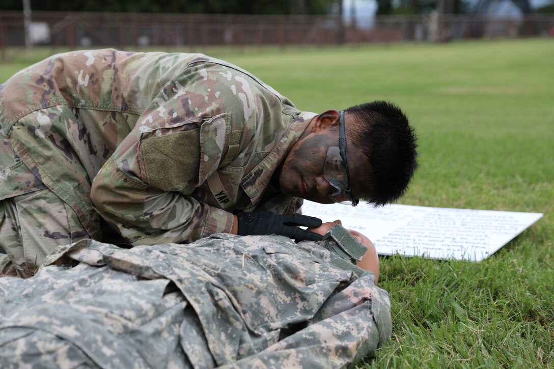 Staff Sgt. Miguel Yap, assigned to the 35th Combat Sustainment Support Battalion, treats an injured dummy during a medical/first aid event held as part of the unit’s second annual “Best Warrior” competition Oct. 13 on Camp Zama, Japan.
