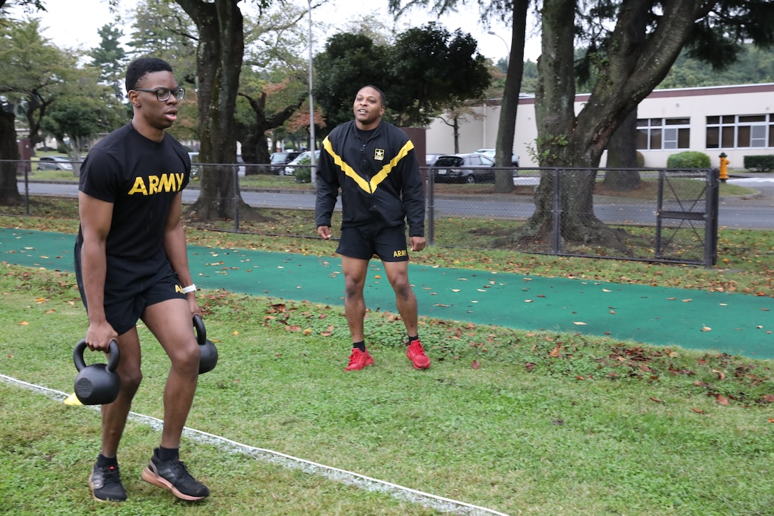 Spc. Demarr Richmond, left, assigned to the 35th Combat Sustainment Support Battalion, conducts an event during the Army Combat Fitness Test while Sgt. Lenworth Lennon, right, assigned to the 311th Military Intelligence, right, cheers him on, during the 35th CSSB’s second annual “Best Warrior” competition Oct. 13 on Camp Zama, Japan.
