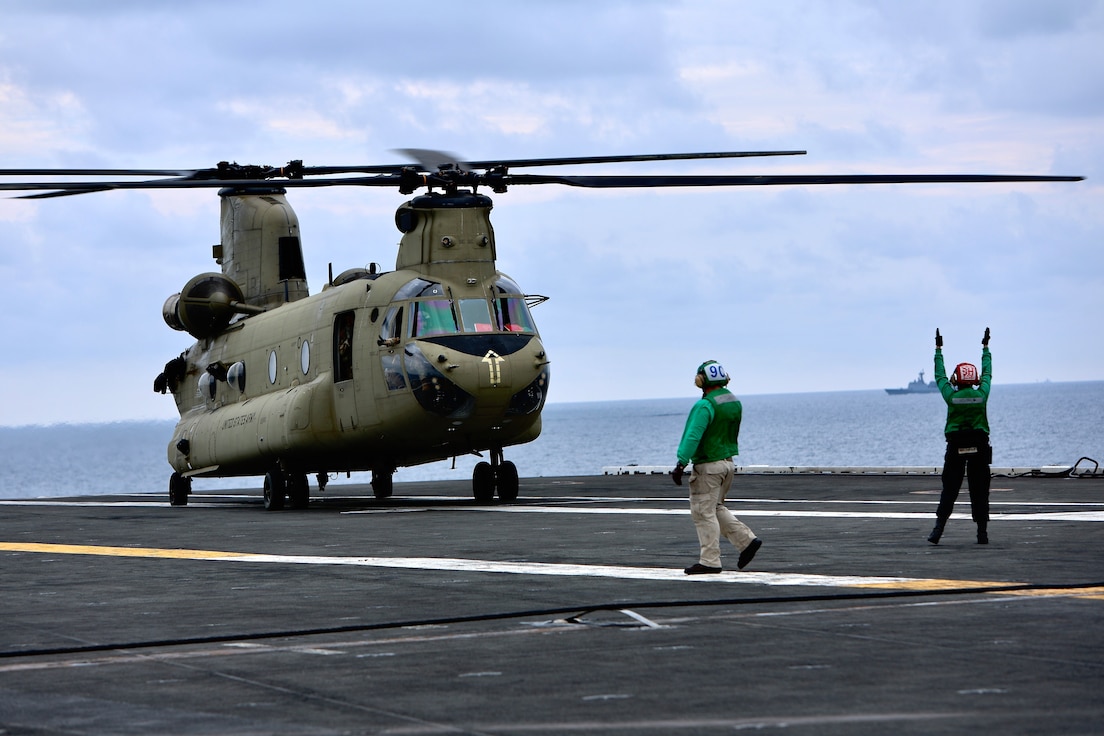 Soldiers from B Company, 3-2 General Support Aviation Battalion, 2nd Combat Aviation Brigade conducted deck landings with CH-47F Chinook helicopters on the the U.S. Navy's only forward-deployed aircraft carrier, USS Ronald Reagan (CVN 76), in the waters east of the Korean peninsula on September 26, 2022. Deck landing qualifications are conducted to certify air crew members and pilots on landing on a ship. This training was conducted in part with the Maritime Counter Special Operations Exercise (MCSOFEX) to strengthen interoperability with our joint partners.