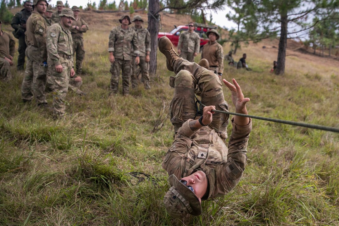 U.S. Army Spc. Daniel Johnson, an infantryman with Bravo Company, 2nd Battalion, 27th Infantry Regiment, 3rd Infantry Brigade Combat Team, 25th Infantry Division, demonstrates how to cross a single rope bridge with the hand-over-hand method during Exercise Cartwheel, Nadi, Fiji, September 18, 2022. Bilateral military-to-military training with the RFMF builds expeditionary readiness and interoperability by increasing the capacity to face crises and contingencies by developing and stressing units at the highest training levels.