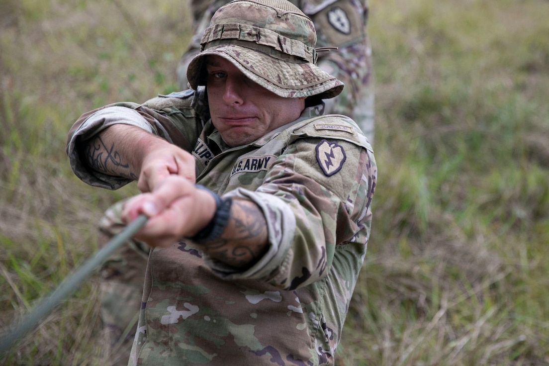 U.S. Army Staff Sgt. Zachery Phillips, a squad leader with Bravo Company, 2nd Battalion, 27th Infantry Regiment, 3rd Infantry Brigade Combat Team, 25th Infantry Division, tightens the rope during a demonstration of how to place a single rope bridge at Exercise Cartwheel, Nadi, Fiji, September 18, 2022. Exercise Cartwheel provides tough, realistic training, strengthening RFMF and U.S. Army capacity as regional leaders, increasing security cooperation for a free and open Indo-Pacific.